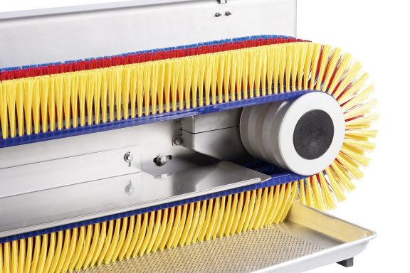 Bunte Reinigungsbürste mit rot-blauem und gelbem Borstenrand.